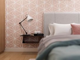 A bedroom with a bed and a bedside table at Kew Villa (Pet) Marhamchurch