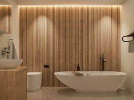 A bathroom with a bathtub, sink, and toilet at Kew Villa (Pet) Marhamchurch