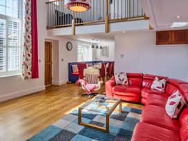 A living room with a sofa and coffee table at Calf House Spa Marhamchurch