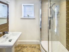 A bathroom with a sink and shower at Calf House Spa in Marhamchurch
