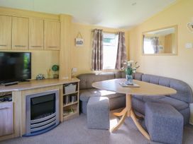A living room with a sofa and table at Caravan 2 at Blackmoor Farm near tenby