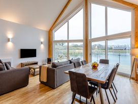 A living room with a sofa and dining area at Tranquillity 4 Carnforth