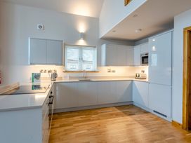 A kitchen with cabinets and appliances at Tranquillity 4 in Carnforth