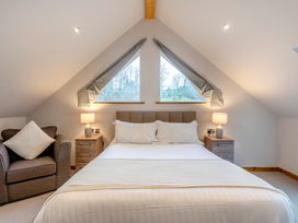 A bedroom with a bed and windows at Tranquillity 4 in Carnforth