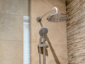 A shower with a fixed and handheld shower head at Tranquillity 4 in Carnforth
