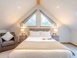 A bedroom with a bed and windows at Tranquillity 4 in Carnforth