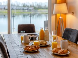 A dining room table with croissants and drinks at Tranquillity 4 (Pet) Carnforth