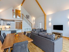 A living room with a sofa and dining table at Tranquillity 4 (Pet) Carnforth