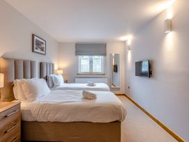 A bedroom with two beds and a television at Tranquillity 4 (Pet) in Carnforth
