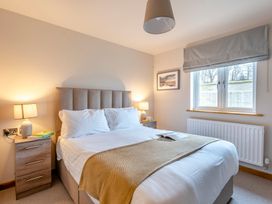 A bedroom with a bed and bedside table at Tranquillity 4 (Pet) Carnforth