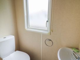 A bathroom with a toilet and washbasin at Caravan 3 at Blackmoor Farm near tenby