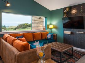 A living room with a sofa and television at The Telfer in North Berwick