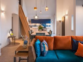 A living room with a sofa and dining area at The Telfer in North Berwick