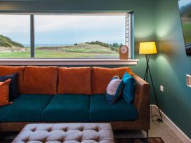 A living room with a couch and a view at The Telfer in North Berwick