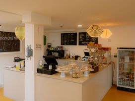 A cafe counter with a coffee machine and display case at The Telfer in North Berwick