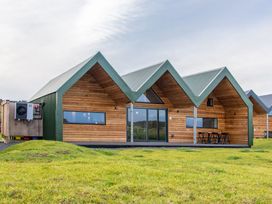 A house with a green roof and wooden exterior at The Irvine in North Berwick