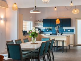 A kitchen with a dining table and chairs at The Irvine in North Berwick