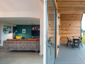 A living room with a sofa and view of a deck at The Irvine in North Berwick