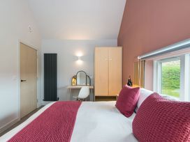 A bedroom with a bed, wardrobe, and desk at The Irvine in North Berwick