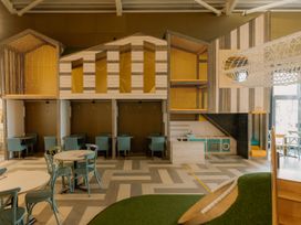 A play area with a playhouse and seating at The Irvine in North Berwick