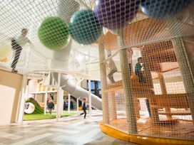 An indoor play area with a climbing structure and slide at The Irvine in North Berwick