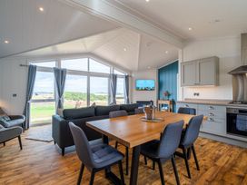 A living room with a dining area and kitchen at The Townsend in North Berwick