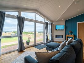 A living room with a sofa and a television at The Townsend in North Berwick