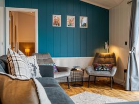 A living room with a sofa and chairs at The Townsend in North Berwick