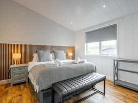A bedroom with a bed and bedside lamp at The Townsend in North Berwick