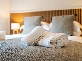 A bedroom with bed and towels at The Townsend in North Berwick