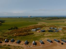 A landscape with huts and fields near the ocean at The Townsend in North Berwick