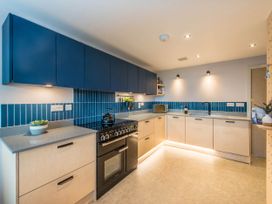 A kitchen with cabinets and stove at The Laidlaw Spa in North Berwick