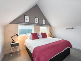 A bedroom with a bed and windows at The Laidlaw Spa in North Berwick