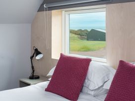 A bedroom with a bed and window view at The Laidlaw Spa North Berwick