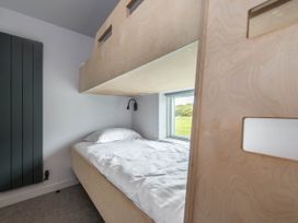 A bedroom with a bunk bed and window at The Laidlaw Spa North Berwick