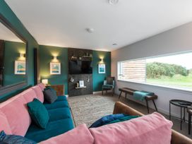 A living room with a sofa and television at The Laidlaw in North Berwick