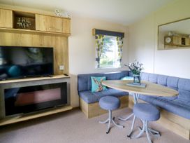 A living room with a sofa and tv at Caravan 6 at Blackmoor Farm near tenby Narberth