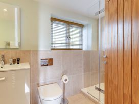 A bathroom with a shower and sink at Godolphin Stable in Bude
