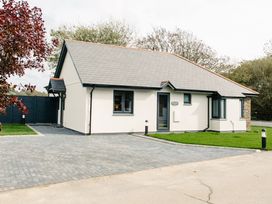 A house with a driveway and garden at Cornish Lodge Spa in Bude