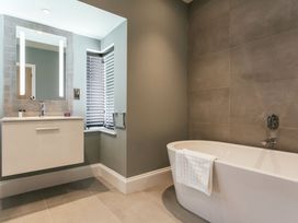 A bathroom with a bathtub and sink at Cornish Lodge Spa in Bude