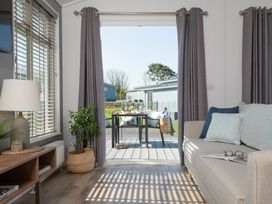 A living room with a view to the deck at Kynance Spa (Pet) in Bude