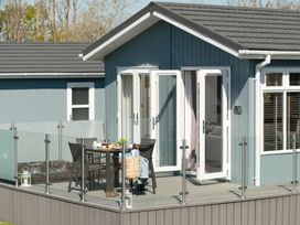 An outdoor area with a table and chairs at Kynance Spa in Bude