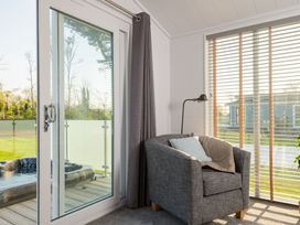 A snug with a sofa and a window at Mullion 2 Spa in Bude