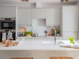 A kitchen with a sink and various kitchen appliances at Sennen 2 Spa Roof Terrace (Pet) Bude