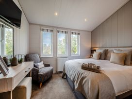 A bedroom with a bed and television at Sennen 2 Spa Roof Terrace (Pet) in Bude