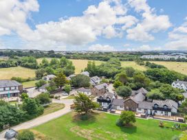 An aerial view of a residential area with houses and trees at Kynance (Pet) Bude