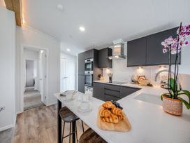 A kitchen with modern appliances and food items at Mullion 2 Spa (Pet) in Bude