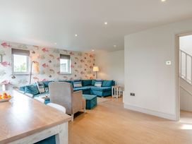 A living room with a sofa and lamp at Summerleaze Garden Cottage 3 Spa in Bude