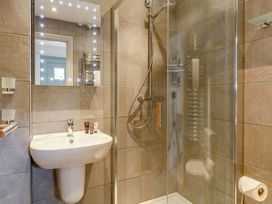 A bathroom with a shower and sink at Summerleaze Garden Cottage 3 Spa Bude