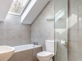 A bathroom with a bathtub and toilet at Summerleaze Garden Cottage 3 Spa, Bude